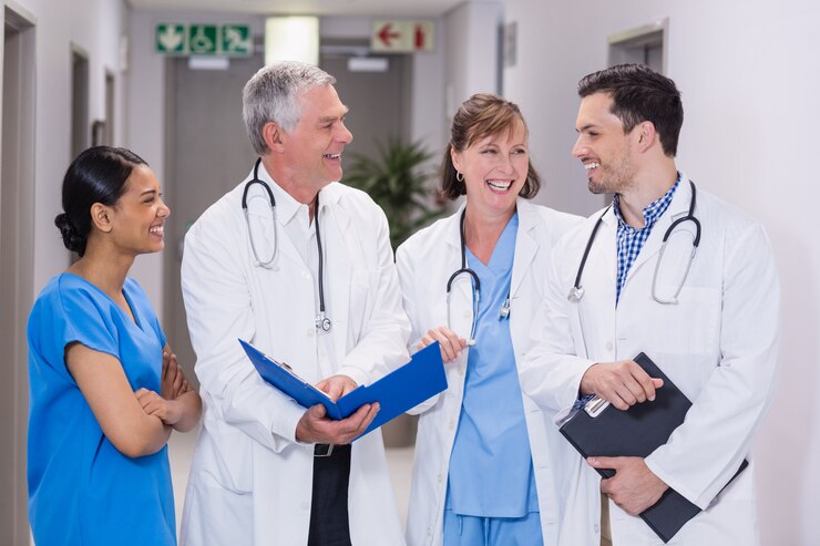 smiling-nurse-doctors-discussing-clipboard_107420-75240